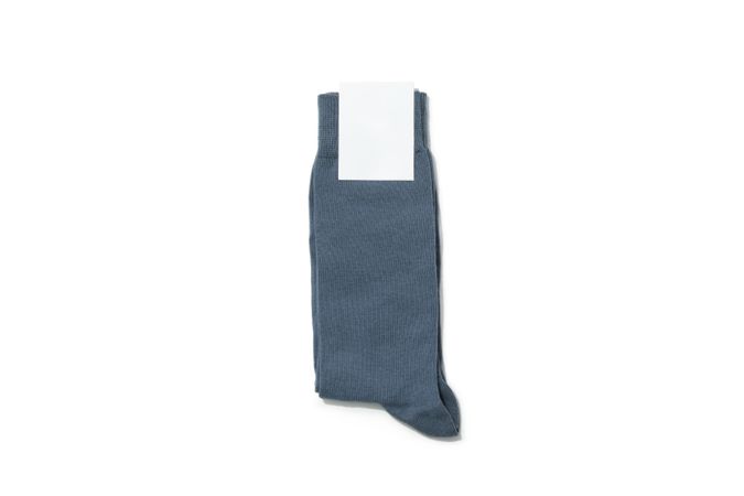 Socks with blank label on light background, space for text
