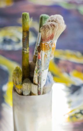 Set of paint brushes on oil painting