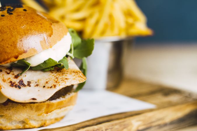 Juicy delicious burger and fried potato on table