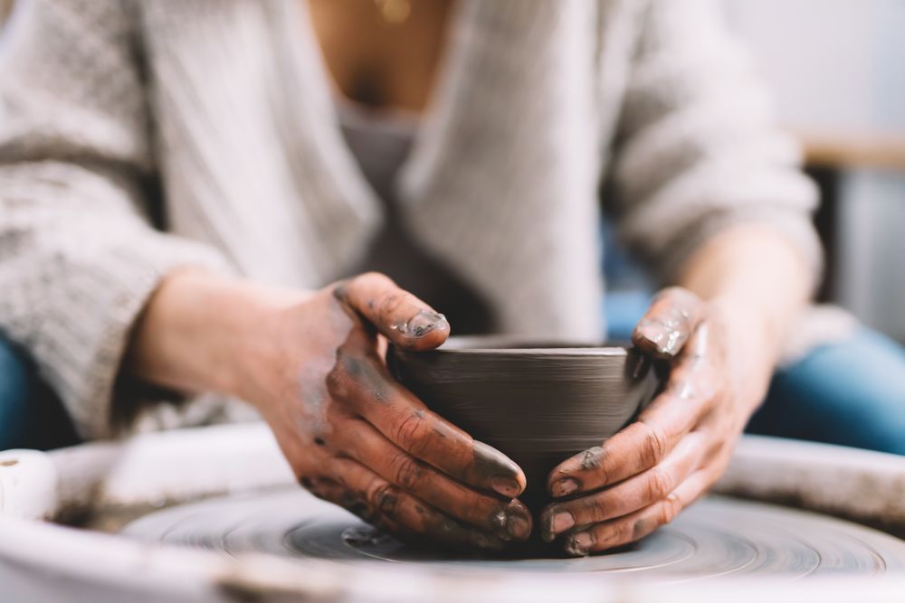 Crop potter shaping vessel on wheel