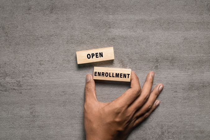 open enrollment words on wooden blocks isolated on cement background