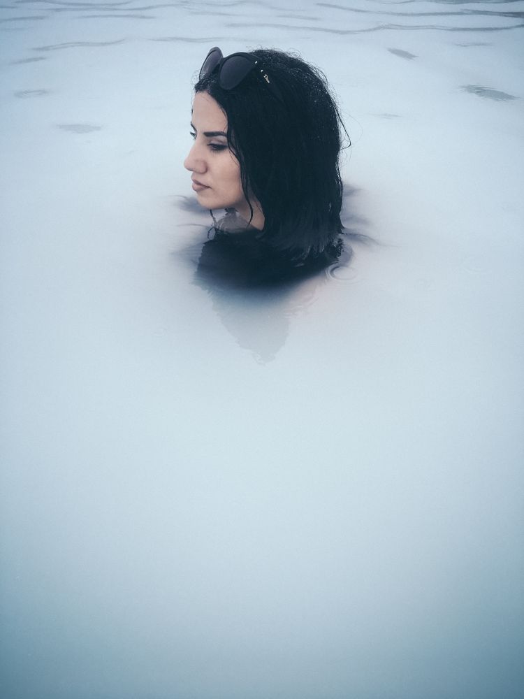 Woman with sunglasses relaxing in a natural spa
