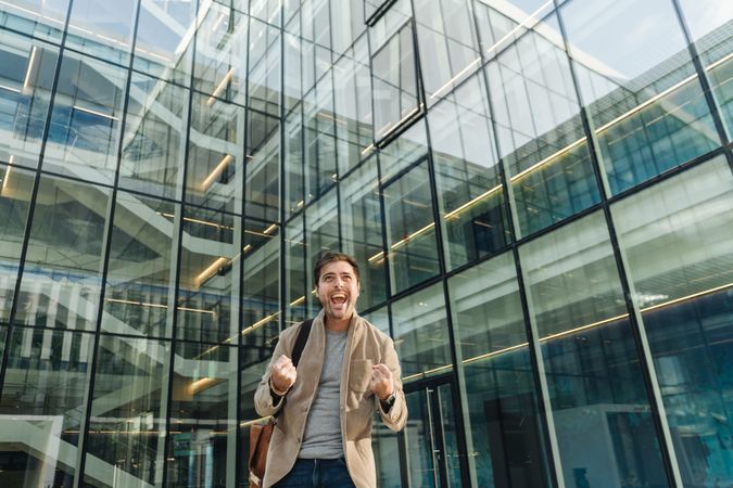 Excited businessman celebrating success on street