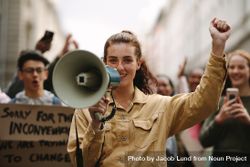 Female activist protesting with megaphone during a strike 0LKAPb
