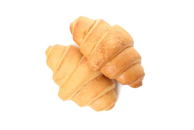 Looking down at two croissants isolated on plain background