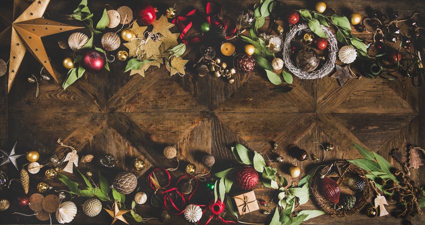 Holiday decorations of stars, baubles, leaves, and ribbon, with copy space