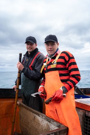 Portrait of two fisherman on a lobster fishing boat