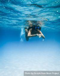 Underwater shot of a person swimming 4dgdl5