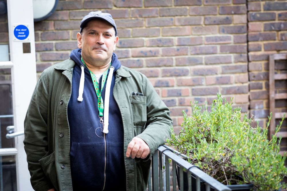 Man leaning on rail outside