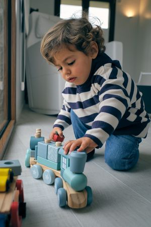 Little boy playing with toy train