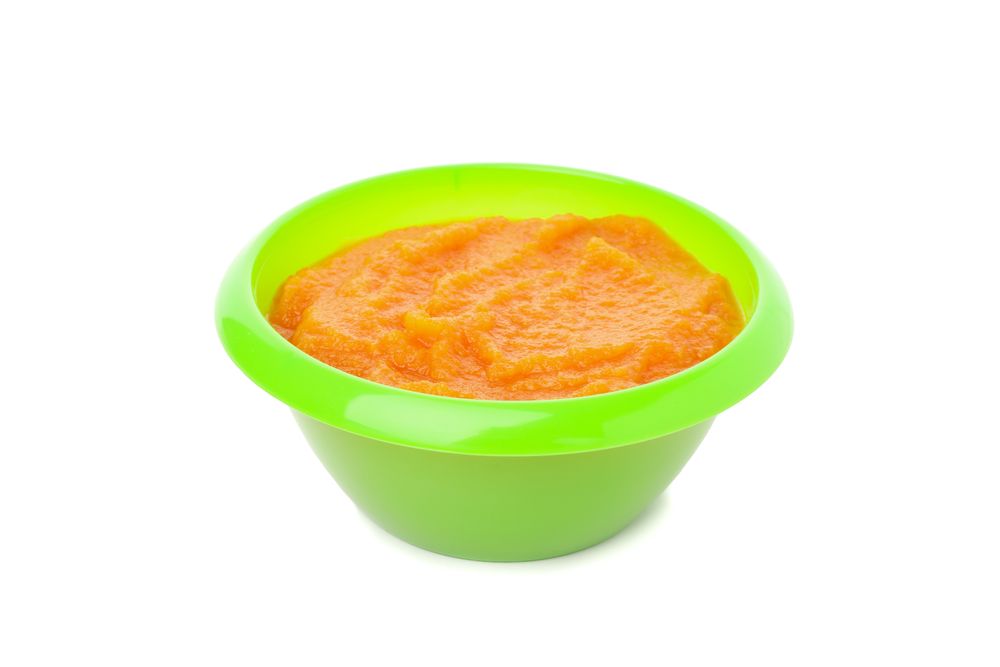 Bowl with healthy baby food isolated on plain background