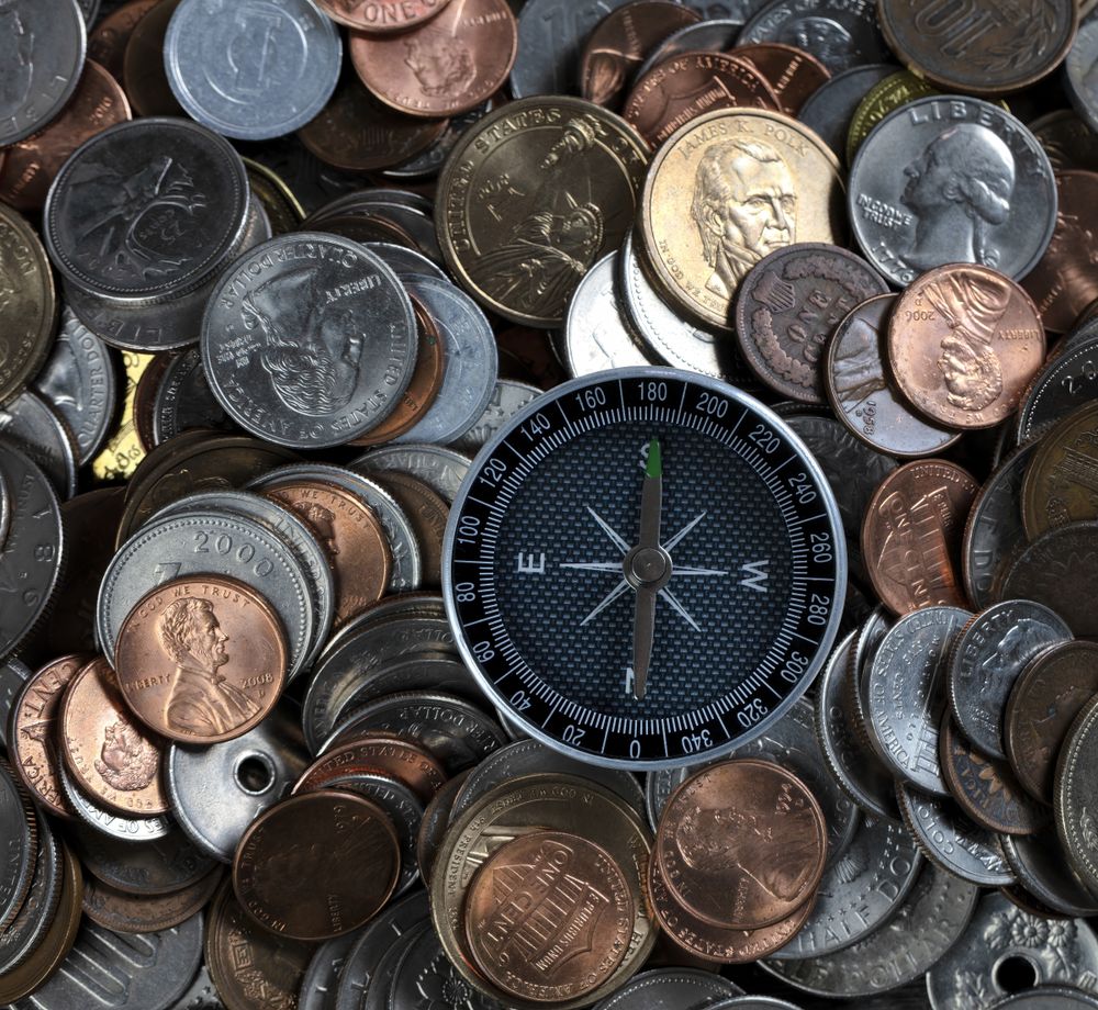 Investing money with a compass to guide to the direction of success