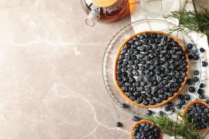 Concept of tasty lunch with blueberry pie on gray table