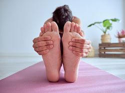 Anonymous woman doing Paschimottanasana A posture