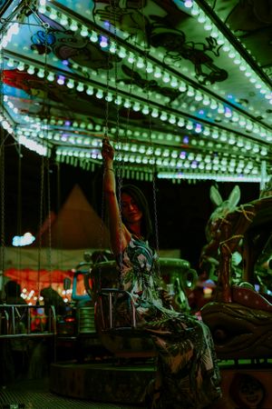Woman enjoying ride on carousel