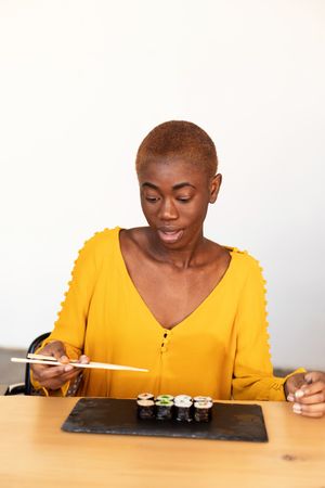 Black woman eating sushi