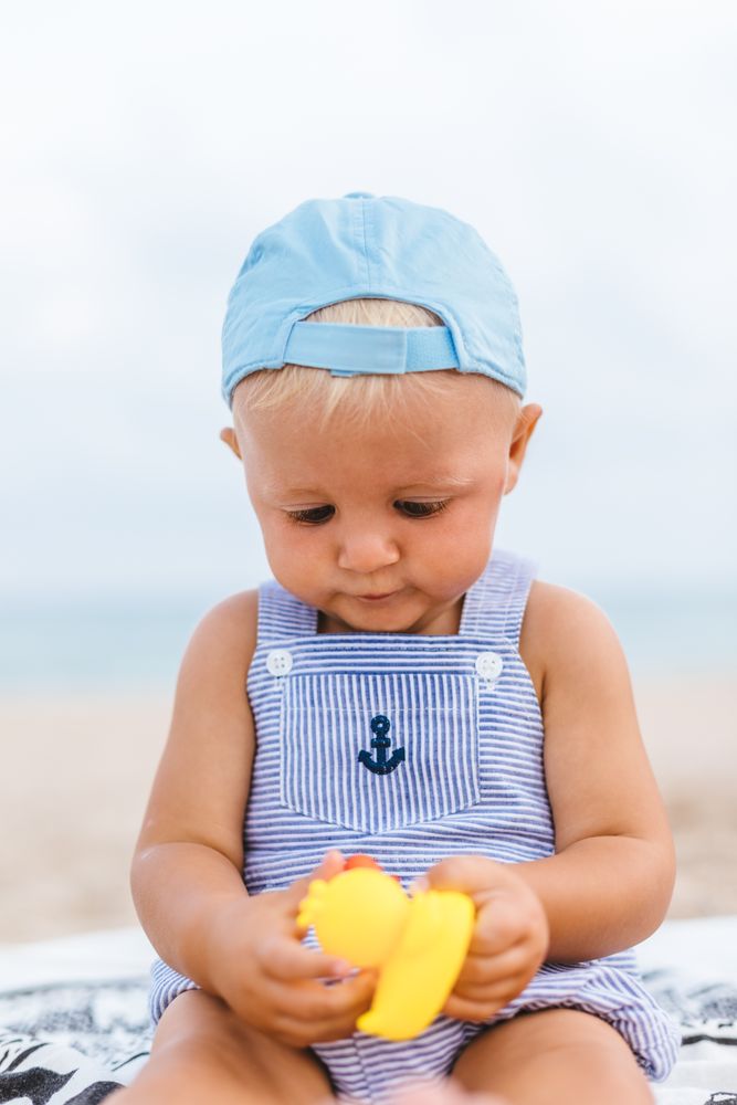 Baby boy playing with rubber ducks