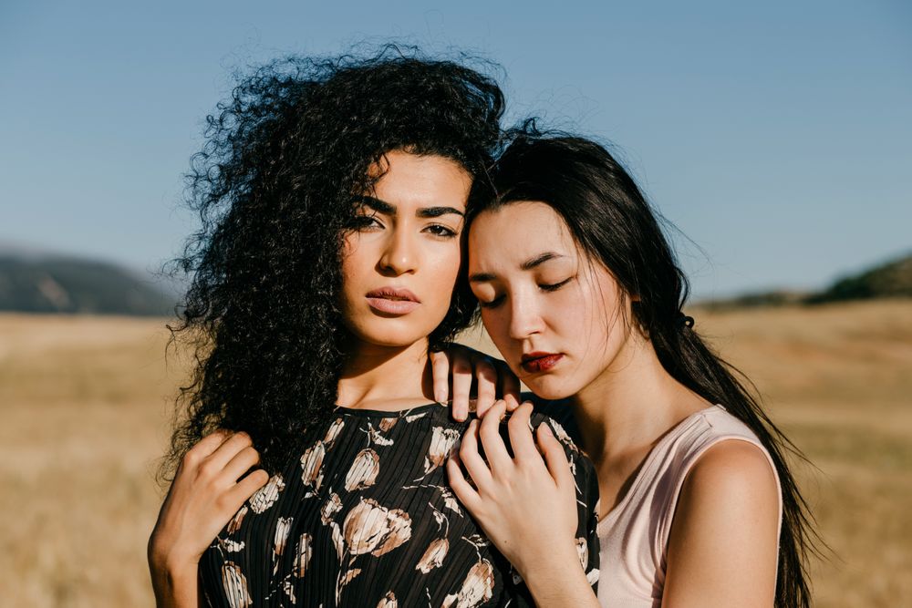 Female friends standing in field