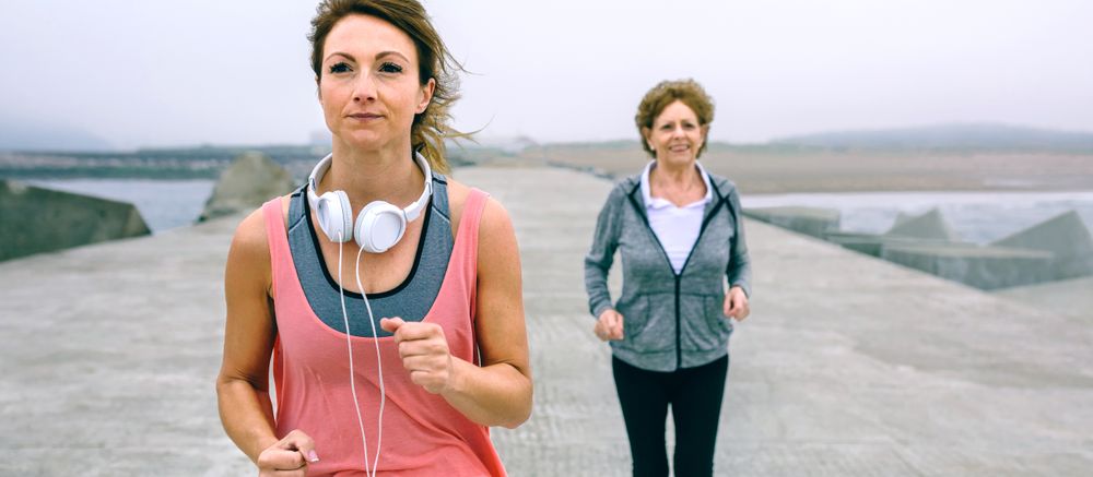Young and older sportswoman running