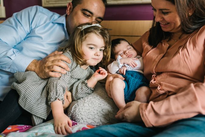 Happy family having fun in bedroom