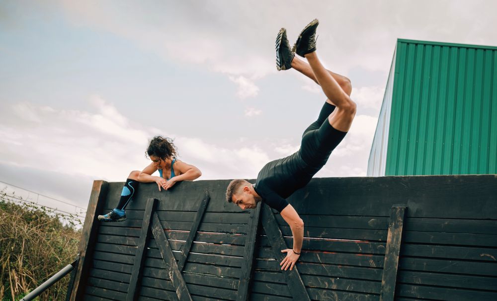 Participants in obstacle course climbing wall