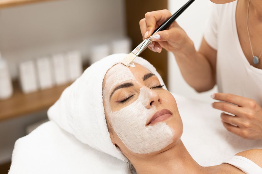 Female having a relaxing face mask professionally applied by beautician