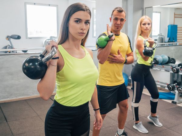 Athletes with kettlebells at the gym