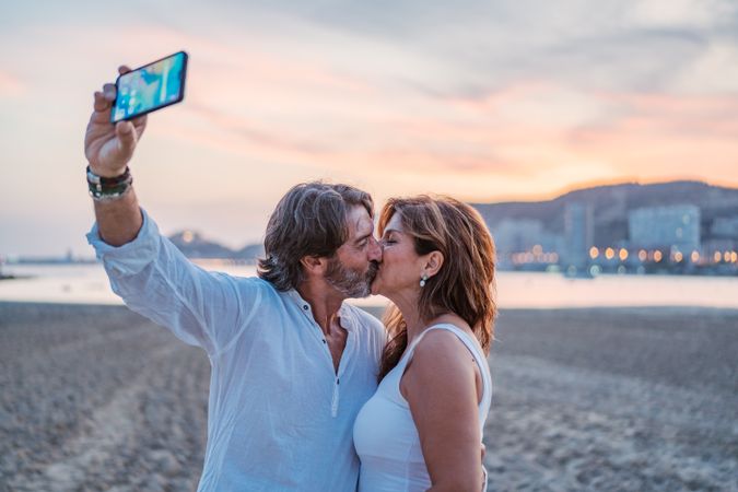Adult couple taking selfie on beach