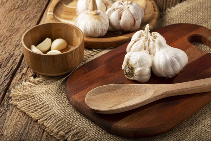 Garlic bulb and garlic cloves on the wooden table.