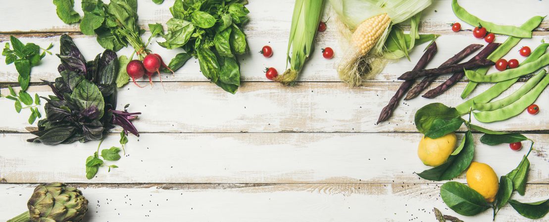 Assortment of seasonal vegetables on painted wooden table with copy space