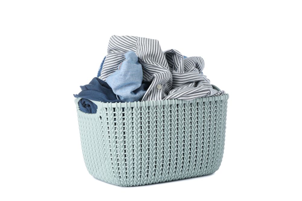 Basket with clothes isolated on blank background