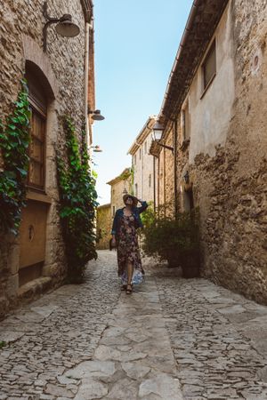 Woman walking in a narrow path in a village