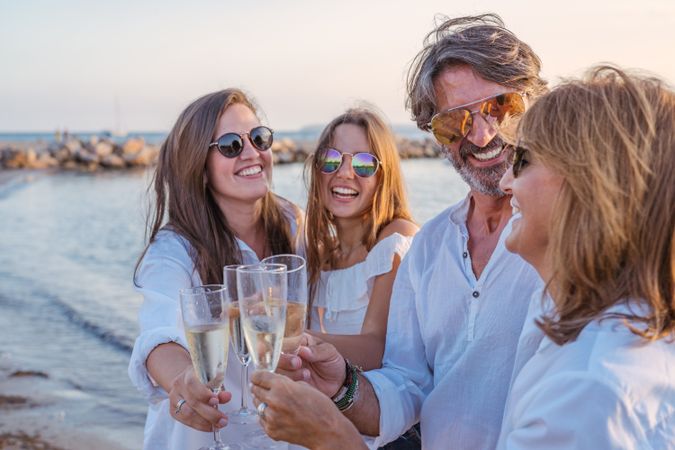 Happy family drinking wine on beach