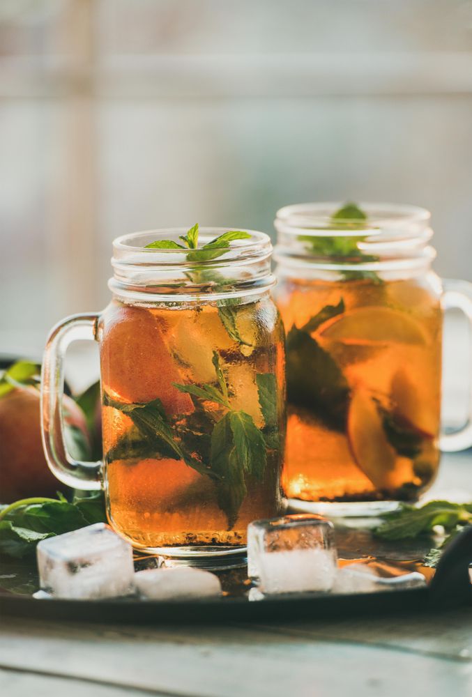 Orange cocktails in mason jars with garnish