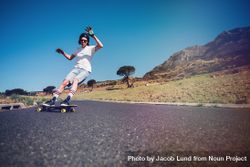 Young man longboarding on a road. 4Bvrk4