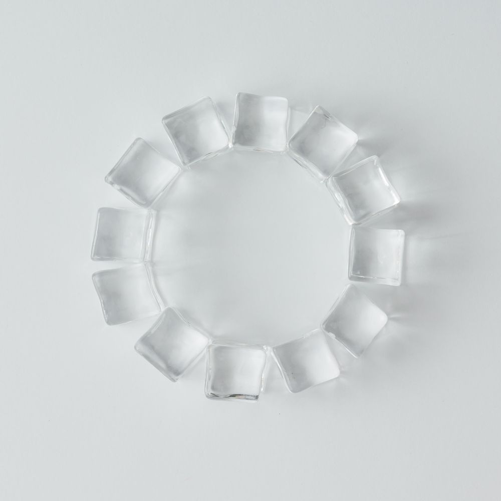 Ice cubes in circle on bright background