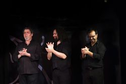 Hispanic men clapping hands during performance