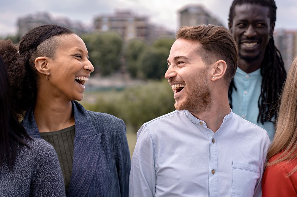 Group of happy multiethnic friends smiling and talking