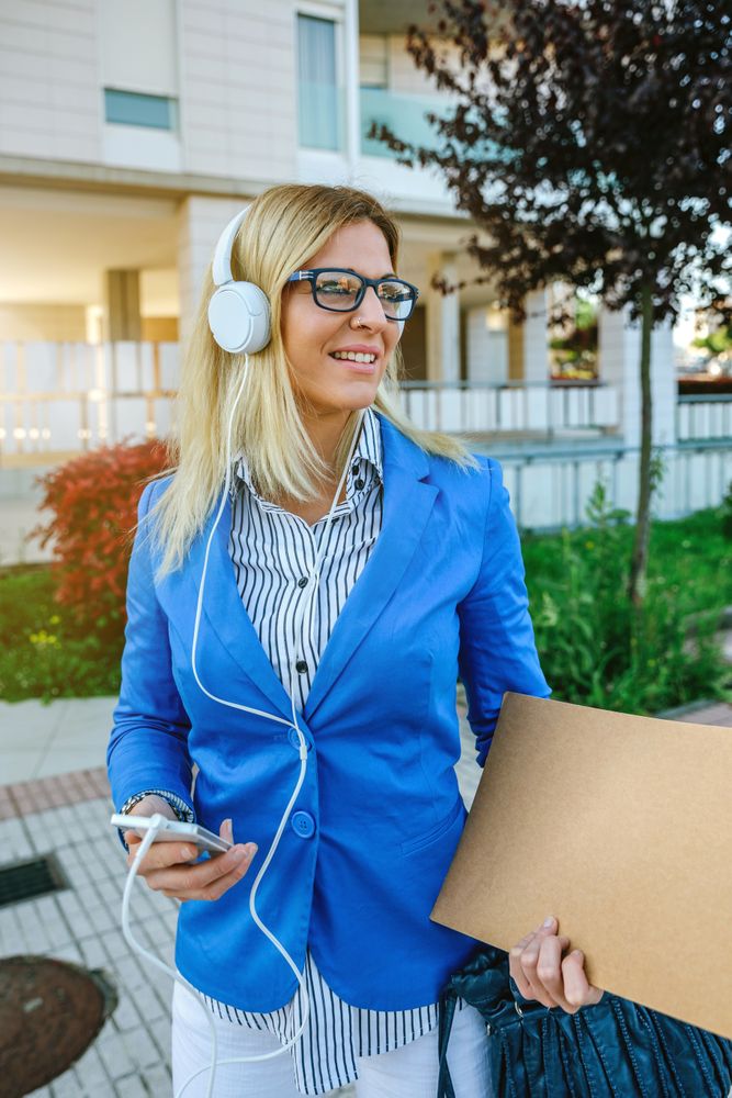 Businesswoman with headphones and mobile