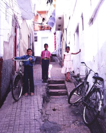 Udaipur, Rajasthan, India - Aug 2003 - Children and bicycles in alley