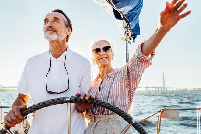 Older couple at the helm of a boat