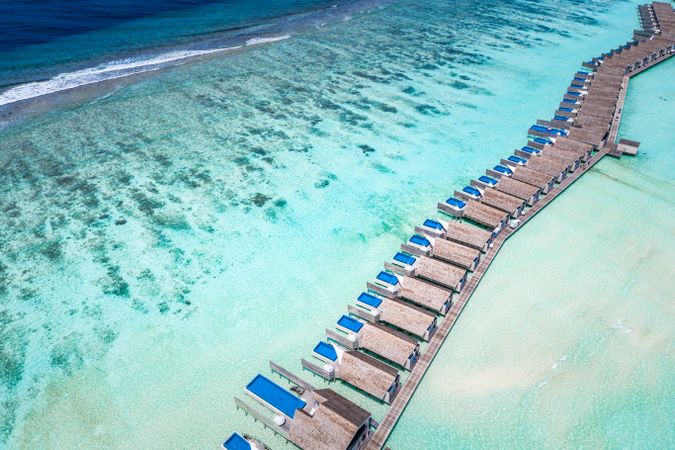 Aerial shot of a row of overwater bungalows with pools in the Maldives