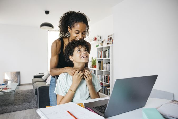 Girl doing her homework with mother
