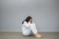 Woman covering her face with hands
