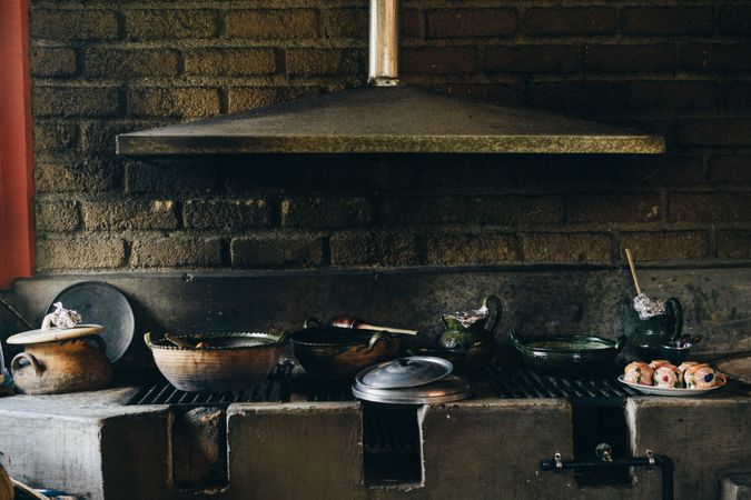 Old grunge stone grill with various utensils
