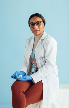 Portrait of a confident doctor on blue background
