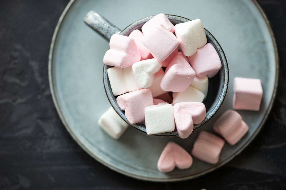 Top view of St. Valentines concept with marshmallow overflowing from mug