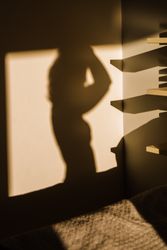 Shadow of a sensual woman projected on a wall
