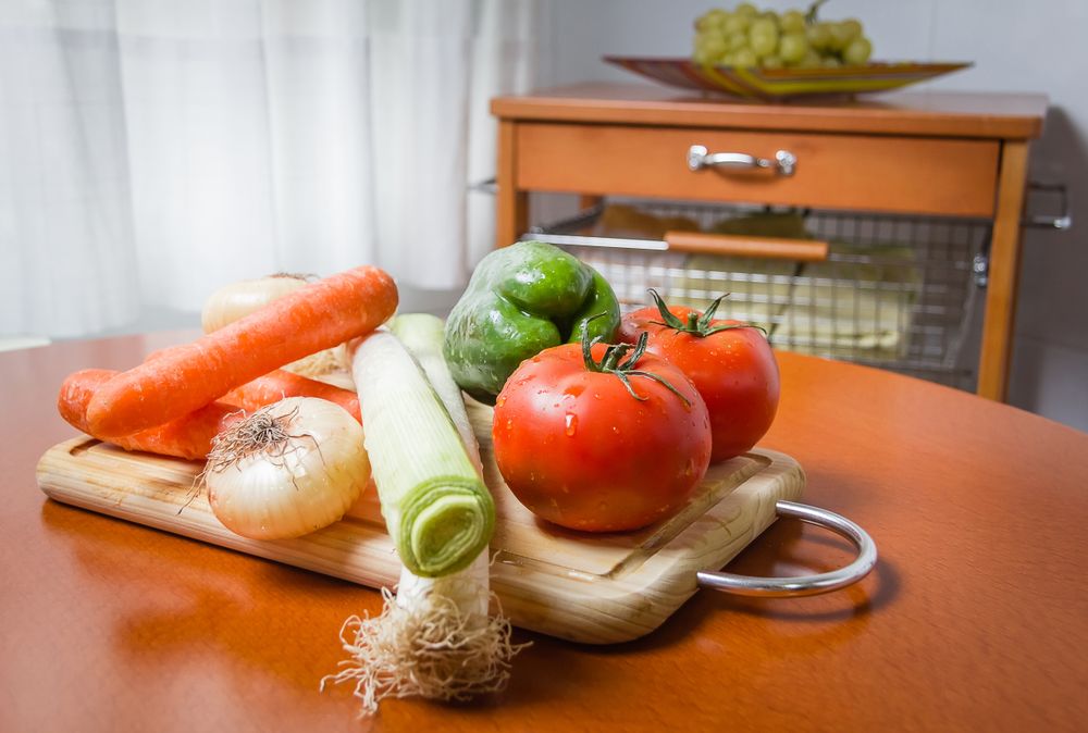 Fresh vegetables on cutting board in the kitchen