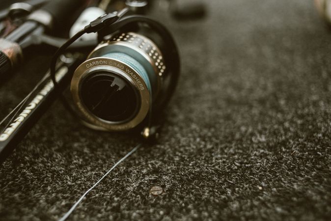 Fishing reel with fishing line on ground